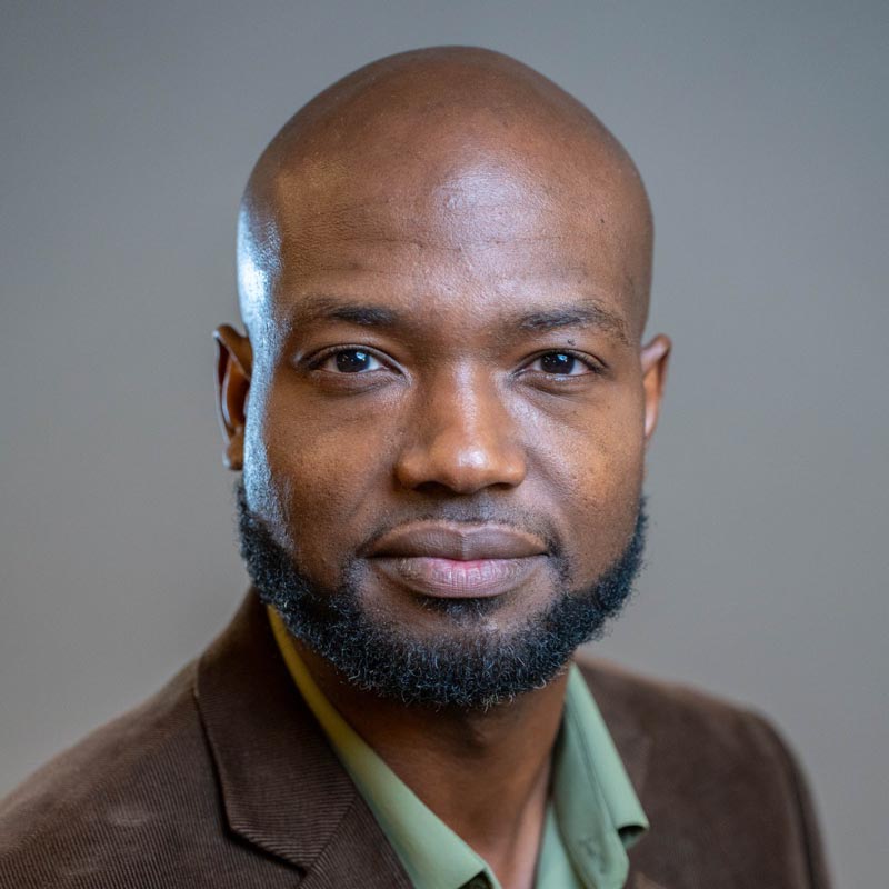 Headshot of Andre Payne smiling at camera