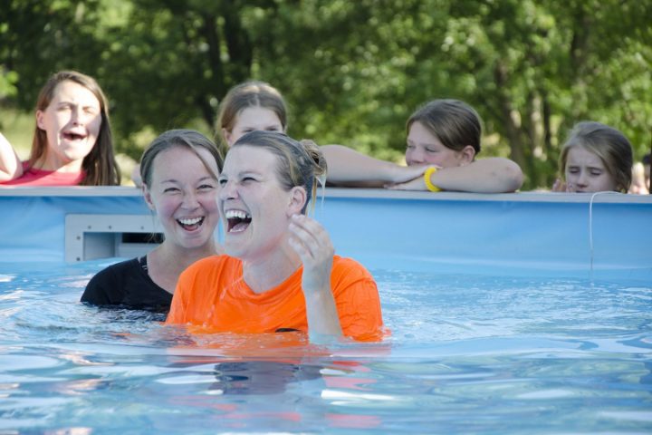 Carrie Stroup in "baptismal pool" with other female