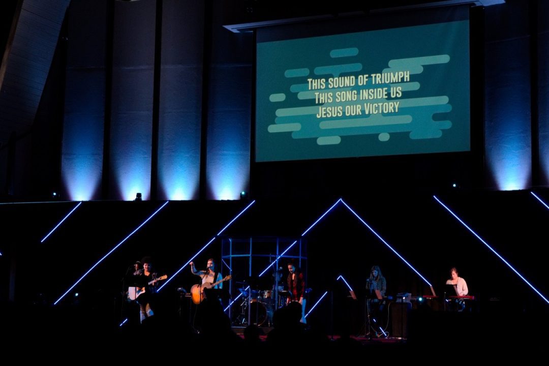 Malone chapel stage showing screen and lighting