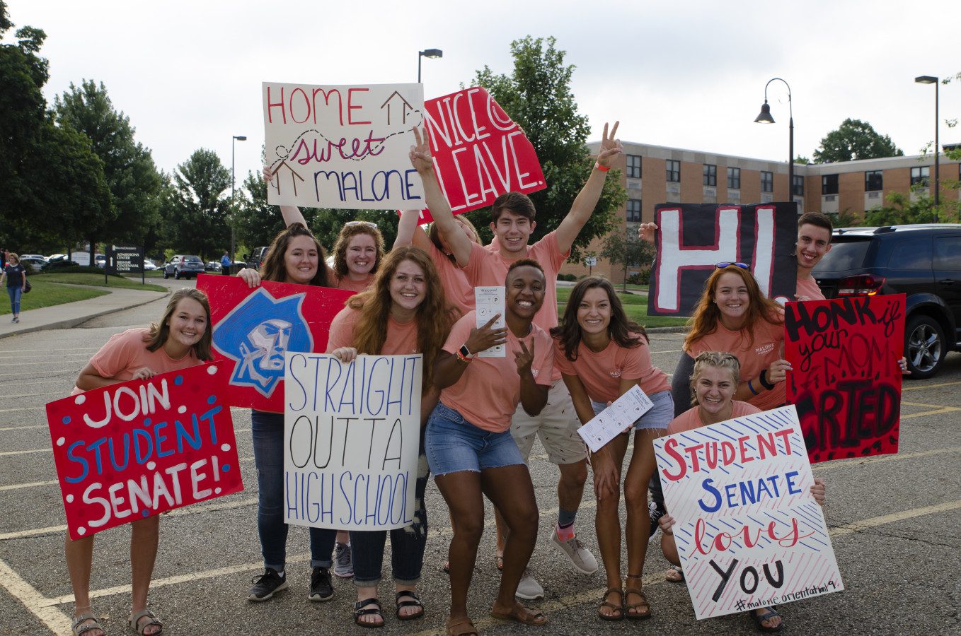 a group of students holding up welcome signs during Welcome Week