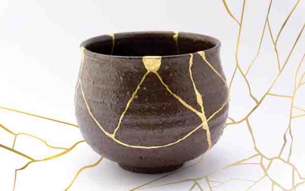 image of a brown pottery bowl with gold accents