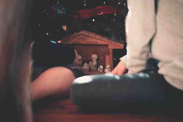 an image of children sitting in front of a nativity scene
