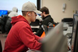 Student coding on computer